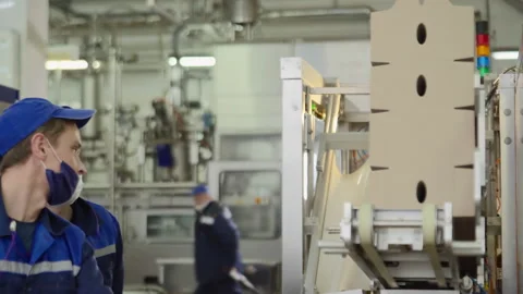 Workers At Packaging Line Stack Cardboard Boxes At Modern Production Factory Stock Footage 269143365