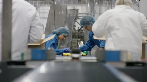Workers packing cosmetics in boxes in cosmetic factory Stock Footage 107990928