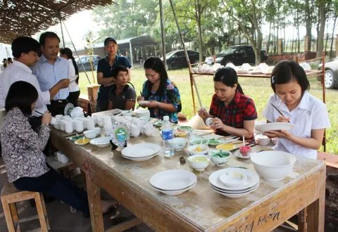Workers paint on ceramics Stock Photos