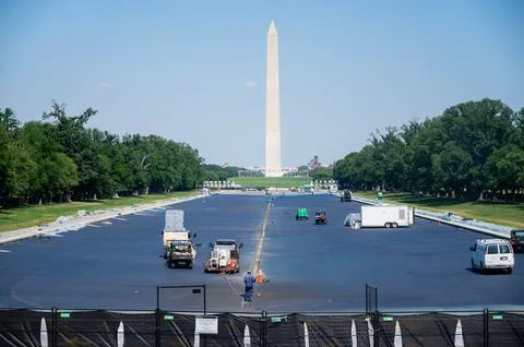 Workers paint the Reflecting Pool Washington Monument background DC Stock Photos
