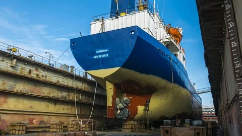 Workers paint the ship in a dry dock. Stock Footage 86782871