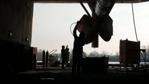 Workers paint the  ship in a dry dock at the shipyard. Stock-Footage 87086292