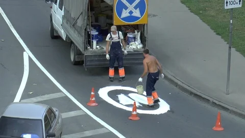 Workers paint traffic sign on the road Stock Footage 95325896