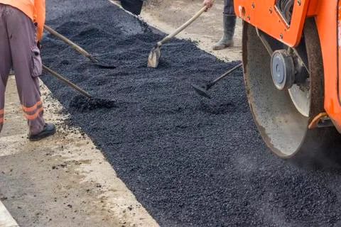 Workers patching asphalt Stock Photos