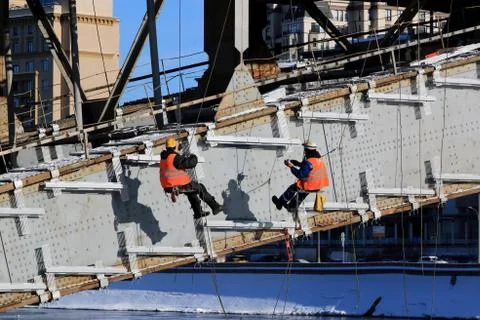 Workers perform work in the winter in cold weather Stock Photos