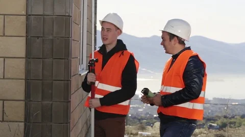 Workers performing level measurements outdoor Stock Footage 75707023
