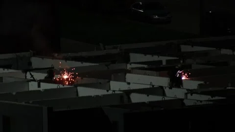 Workers performing welding operation at night on a building construction site Stock Footage 325298816