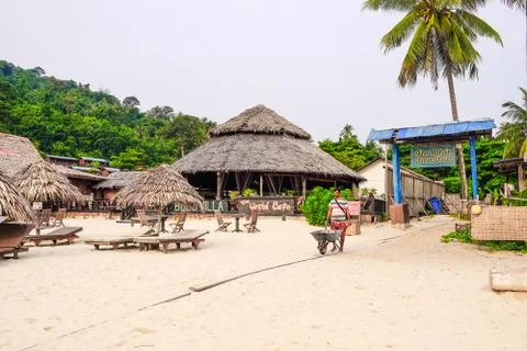 Workers pick up trash using wheelbarrow at Perhentian Island, Malaysia.Vacati Stock Photos