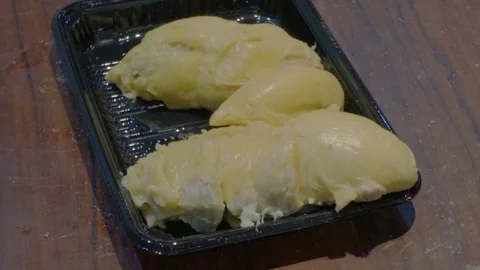 Workers place durian pulp into trays. Video stock 341776087