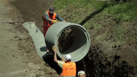 Workers Placing Pipe On Sewer Line.Road Construction Work Stock Footage 49794480