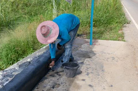 Workers plastering the edge of the footpath Stock Photos