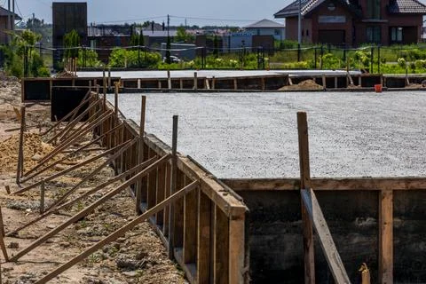 Workers pour cement to create a solid foundation for a new home in a develo.. Stock Photos