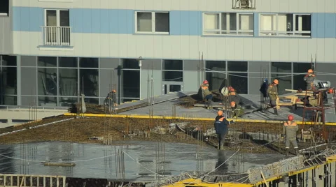 Workers pour concrete at the construction site Stock Footage 63010299