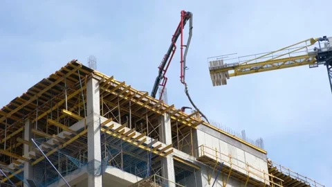 Workers pour concrete at the construction site of a new residential building Stock Footage 234684024
