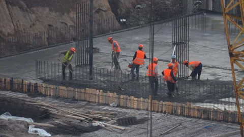 Workers pour concrete on residential house construction Stock Footage