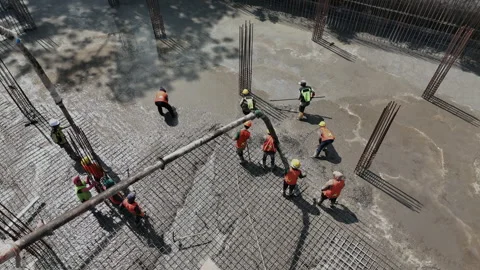 Workers pouring and leveling concrete foundation Aerial view Stock Footage 305886789