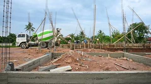 Workers pouring cement foundation for house building Stock Footage 64275922