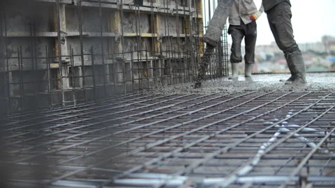Workers pouring concrete at a construction site Stock Footage 283292313