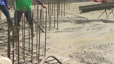 Workers pouring concrete floor Using a cement grinder Stock Footage 271139026