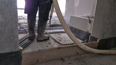 Workers pouring polystyrene concrete floor slow motion Stock Footage 339364019