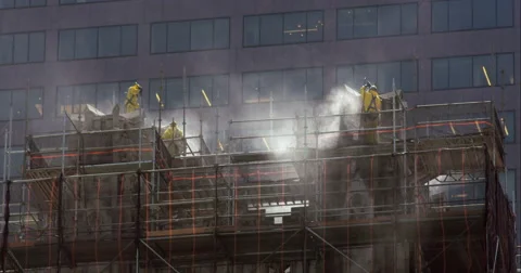 Workers power wash the top of a New York City church. Stock Footage 67243151