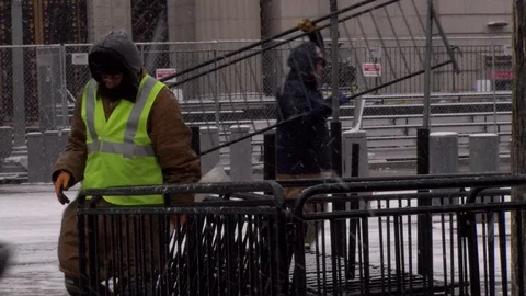 Workers prepare for Donald Trump's inauguration during a winter storm that hi Stock Footage 125867378