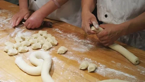 Workers prepare dough on floured board in food industry Stock Footage 337175730