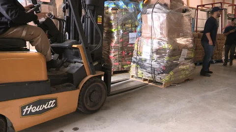 Workers prepare humanitarian aid supplies for middle east Syria Stock Footage 67565784