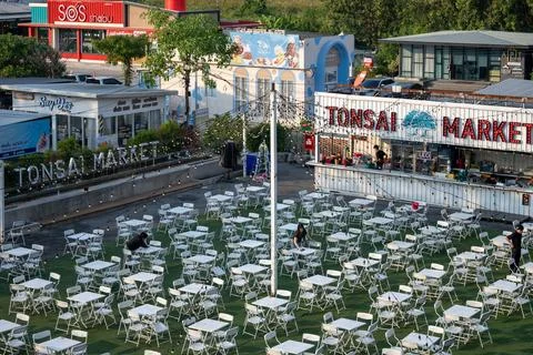 Workers Prepare Outdoor Seating at Tonsai Market Stock Photos