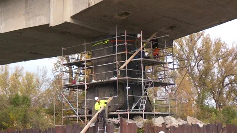 Workers Preparing Charges Under Bridge for Demolition Stock Footage 342019046