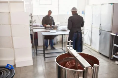 Workers preparing ingredients in a chocolate making factory Stock Photos