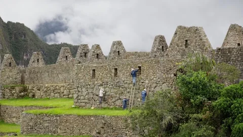 Workers Preserving Quechua Heritage at Machu Picchu Stock Footage 277465744