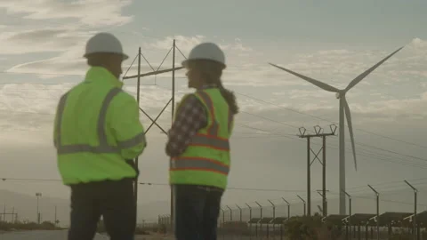 Worker's Problem Solve at Work Site with Wind Turbines and Power Lines Vidéo 208781537