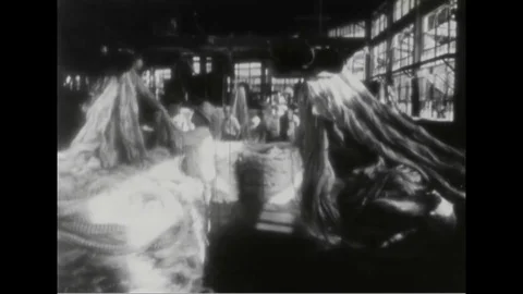 Workers process hemp from industrial machinery - 1953 Stock Footage 105530517