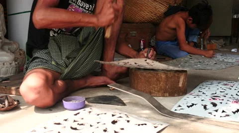 Workers produce hand made stencils for religious purposes - Myanmar Stock Footage 61204703