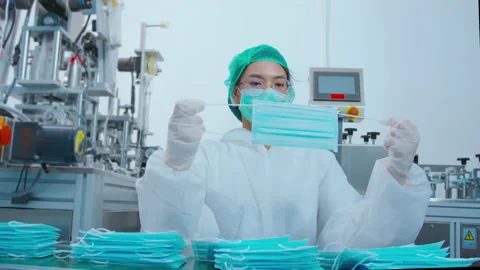 Workers producing surgical mask in modern factory, Covid-19 protection and me Stock Footage 158175872