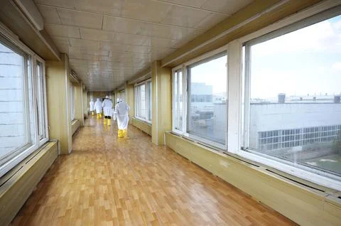 Workers in protective clothes going down the passageway of the Chernobyl Nucl Stock Photos