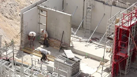 Workers with protective clothing on a large scale construction site Stock Footage 72112170