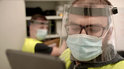 Workers in Protective Face Masks Checking Inventory in Fulfillment Center Stock Footage 140257606