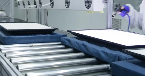 Workers in protective gowns, gloves and masks work on a conveyor belt for the Stock Footage 281480244