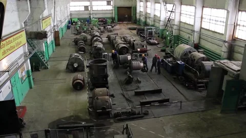 Workers in protective helmets repair huge old electric motors 스톡 동영상 125547942
