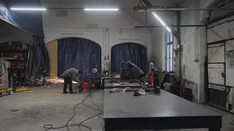 The workers in protective masks welding and grinding metal parts Stock Footage 265190727