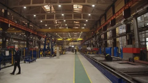 Workers in protective uniform and safety helmets weld steel structures in the Stock Footage 202048921