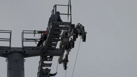 Workers pull multi-ton metal structure to platform support. Close-up. Stock Footage 106168976