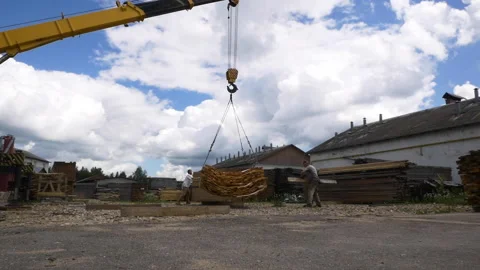 Workers put boards under planks pile at woodworking plant Stock Footage 141119827
