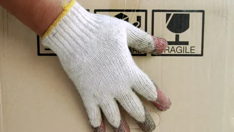 Workers put a box with a warning label. Stock Footage 154923984