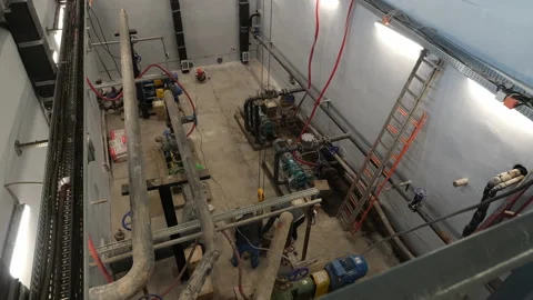 Workers put boxes on pallet in shop with pipes compressors Stock Footage 155997010