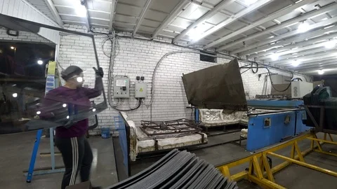 Workers put car glass on the frame. Bending furnace. Stock-Footage 97331835