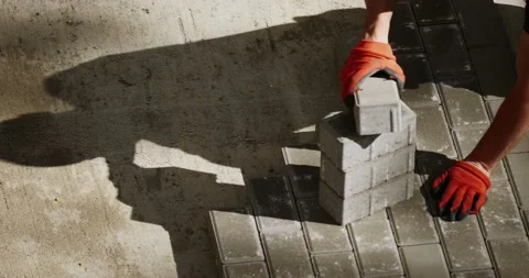 Workers put concrete bricks on a new pedestrian way -- close-up shot from above Stock Footage 89910437