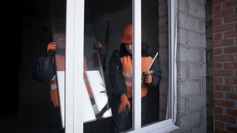 Workers put the glass in the window frame Stock Footage 82303561